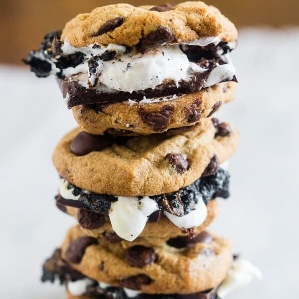 These peanut butter chocolate chip cookie s'mores take all the flavor of a childhood favorite and kick it up a few notches! What's not to love about toasted marshmallows and dark chocolate sandwiched in between peanut butter chocolate chip cookies?