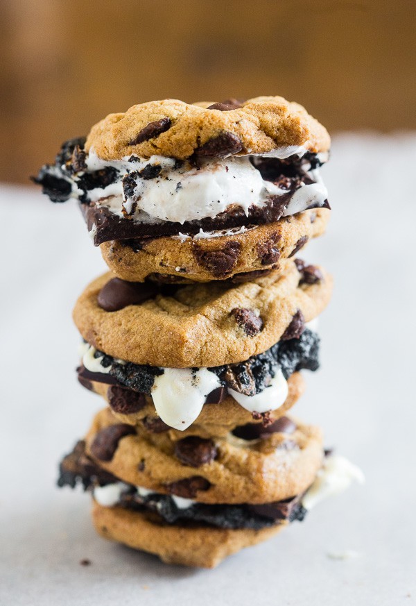 These peanut butter chocolate chip cookie s'mores take all the flavor of a childhood favorite and kick it up a few notches! What's not to love about toasted marshmallows and dark chocolate sandwiched in between peanut butter chocolate chip cookies?