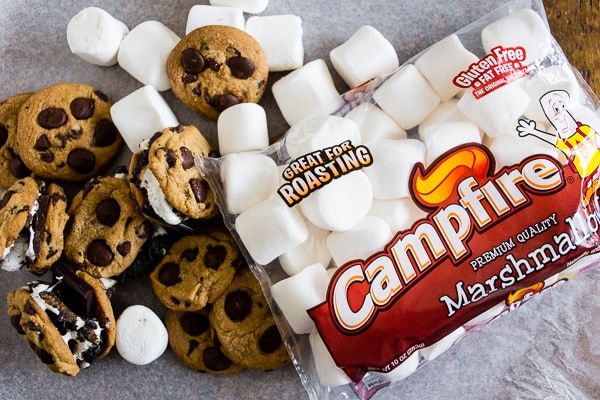These peanut butter chocolate chip cookie s'mores take all the flavor of a childhood favorite and kick it up a few notches! What's not to love about toasted marshmallows and dark chocolate sandwiched in between peanut butter chocolate chip cookies?