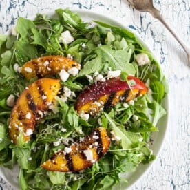 This grilled nectarine salad combines two of my favorite summer things - salads and grilling! Sweet nectarines lightly grilled and tossed into a bed of arugula, ricotta salata and drizzled with a light honey balsamic dressing. You'll love how much flavor is packed into this beauty!