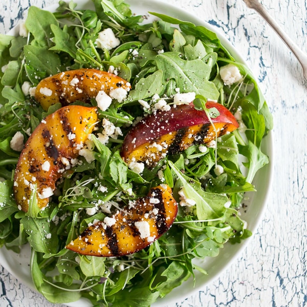 This grilled nectarine salad combines two of my favorite summer things - salads and grilling! Sweet nectarines lightly grilled and tossed into a bed of arugula, ricotta salata and drizzled with a light honey balsamic dressing. You'll love how much flavor is packed into this beauty!
