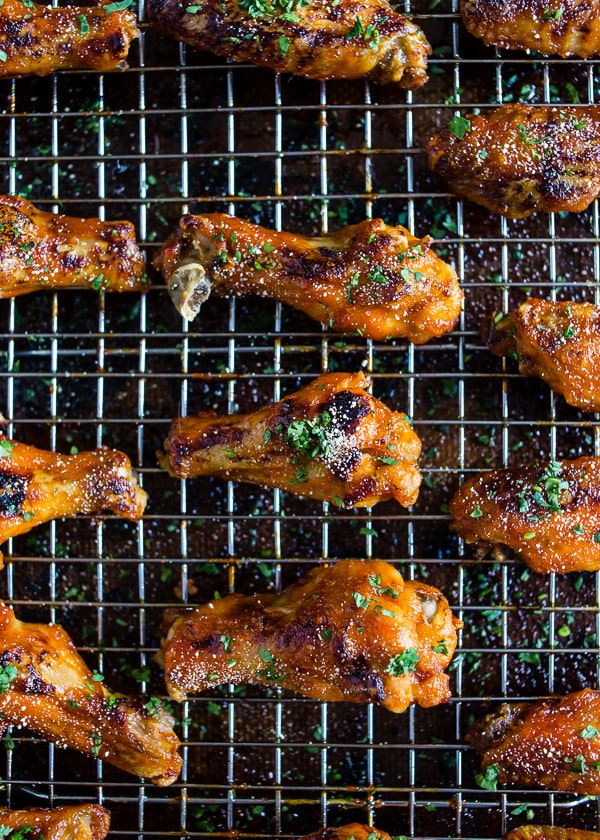 These sweet and spicy honey sriracha chicken wings are the perfect game day appetizer or weeknight dinner. Baked in the oven so they come out super crispy and glazed to perfection.