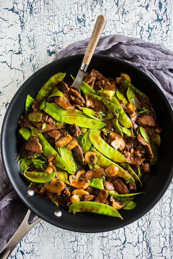 Beef Snow Pea Skillet in a skillet with a spoon.