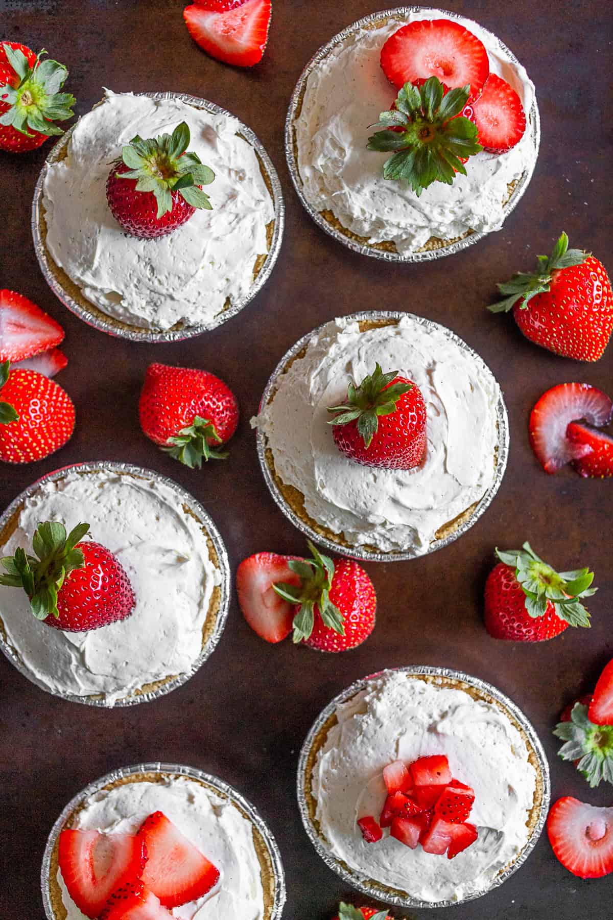 Six No Bake Strawberry Tarts sitting on a table. 
