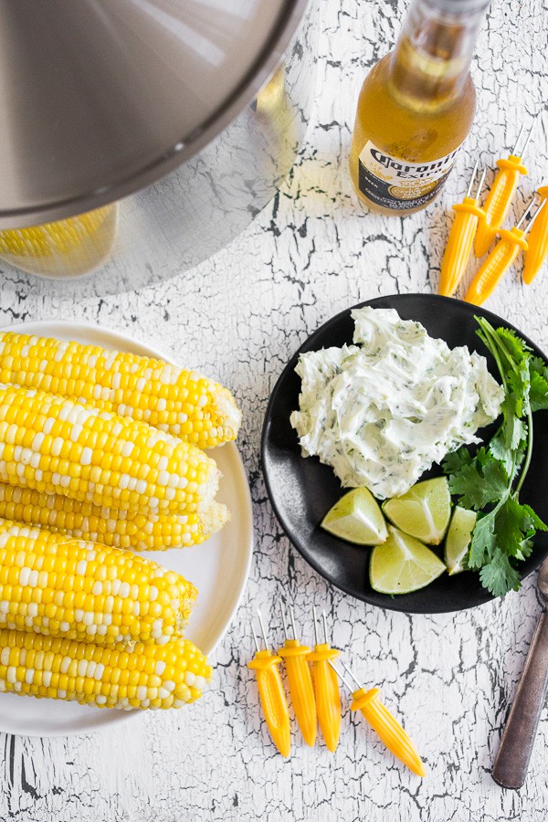 Beer Steamed Corn on the Cob on a plate with honey butter on a plate. 