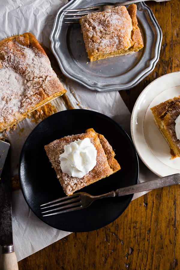 Pumpkin Churro Cheesecake Bars on a plate with a fork. 