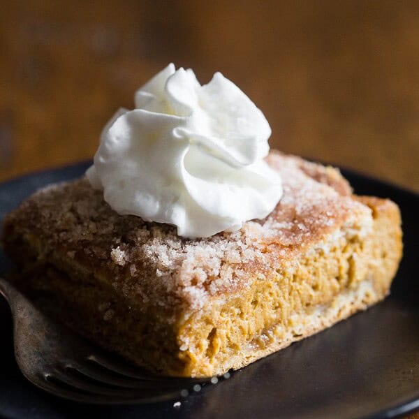 These pumpkin churro cheesecake bars are going to be your new favorite fall treat! A fun twist to pumpkin cheesecake with a crispy pumpkin spice sugar crescent roll topping. Super easy to make and perfect for all you holiday dessert tables!