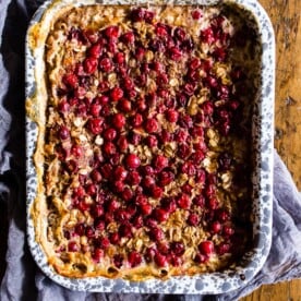 This baked cranberry oatmeal is ready in under an hour and reheats perfectly for a hearty breakfast all week long. Plus it's a great use for all those fall cranberries and delicious maple syrup.