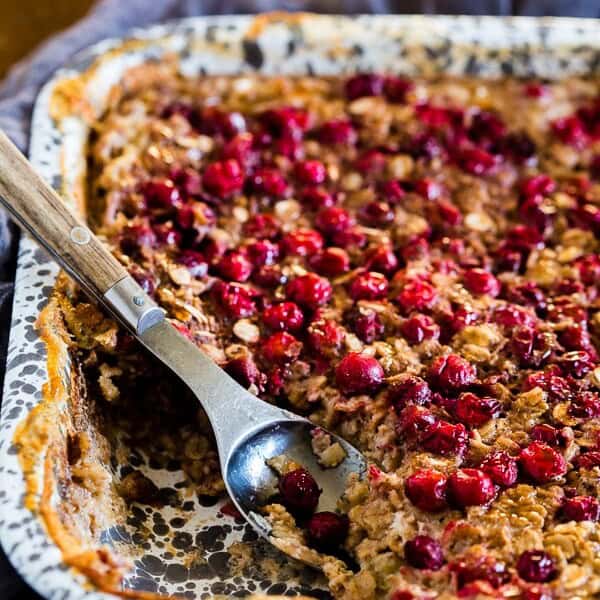 This baked cranberry oatmeal is ready in under an hour and reheats perfectly for a hearty breakfast all week long. Plus it's a great use for all those fall cranberries and delicious maple syrup.