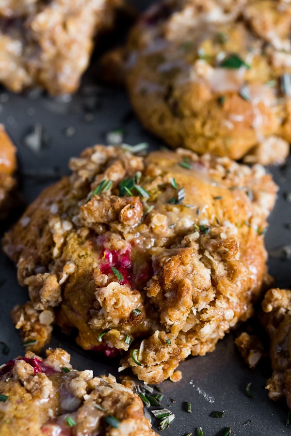 Cranberry Orange Rosemary Muffins topped with orange glaze. 
