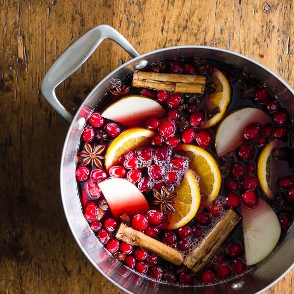 This spiced mulled wine is just what your holiday party needs! Full of red wine, apple cider, whole spices and lots of fresh fruit. You'll love how cozy you'll feel sipping on a mug of this deliciousness.
