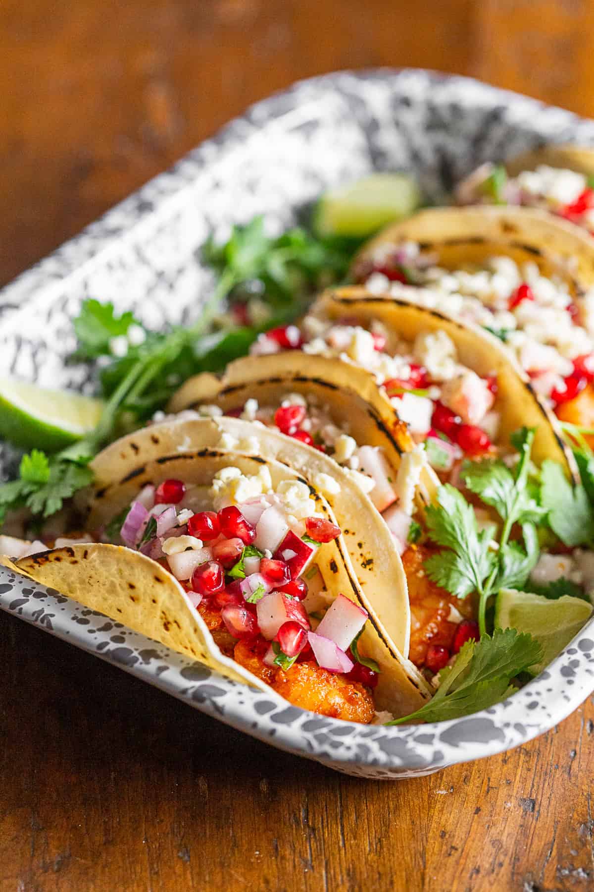 Shrimp Tacos toped with fruit salsa and cheese.