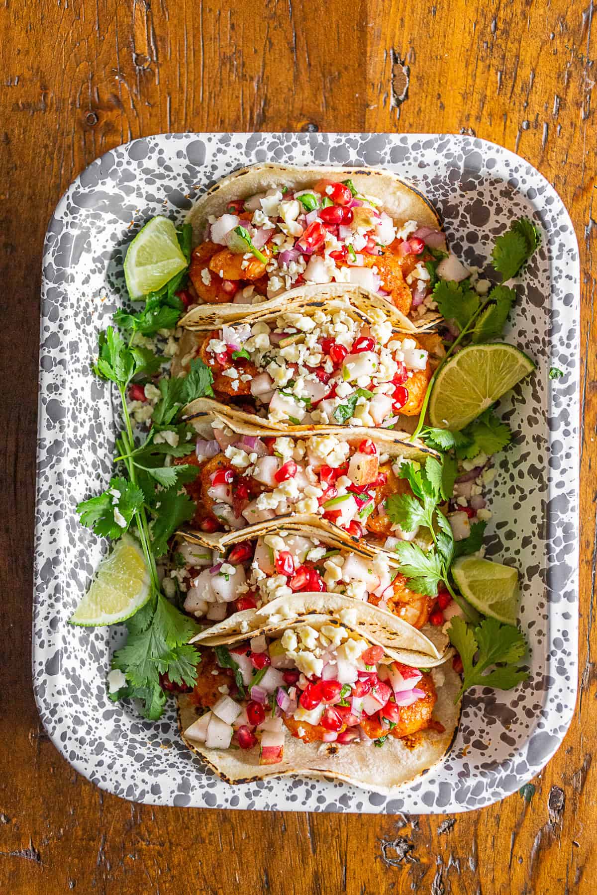 Shrimp Tacos with apple pomegranate salsa in a serving dish.