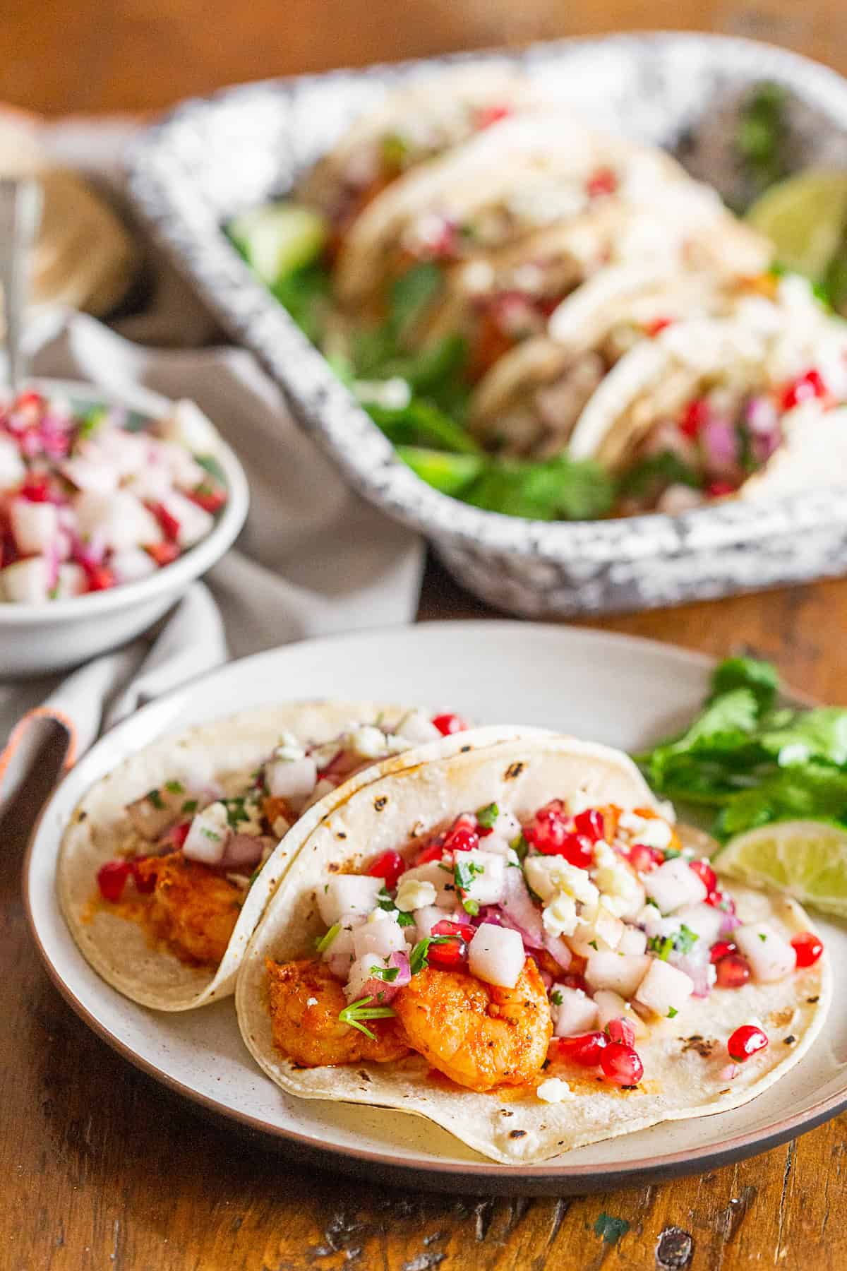 Shrimp Tacos on a plate topped with fruit salsa.