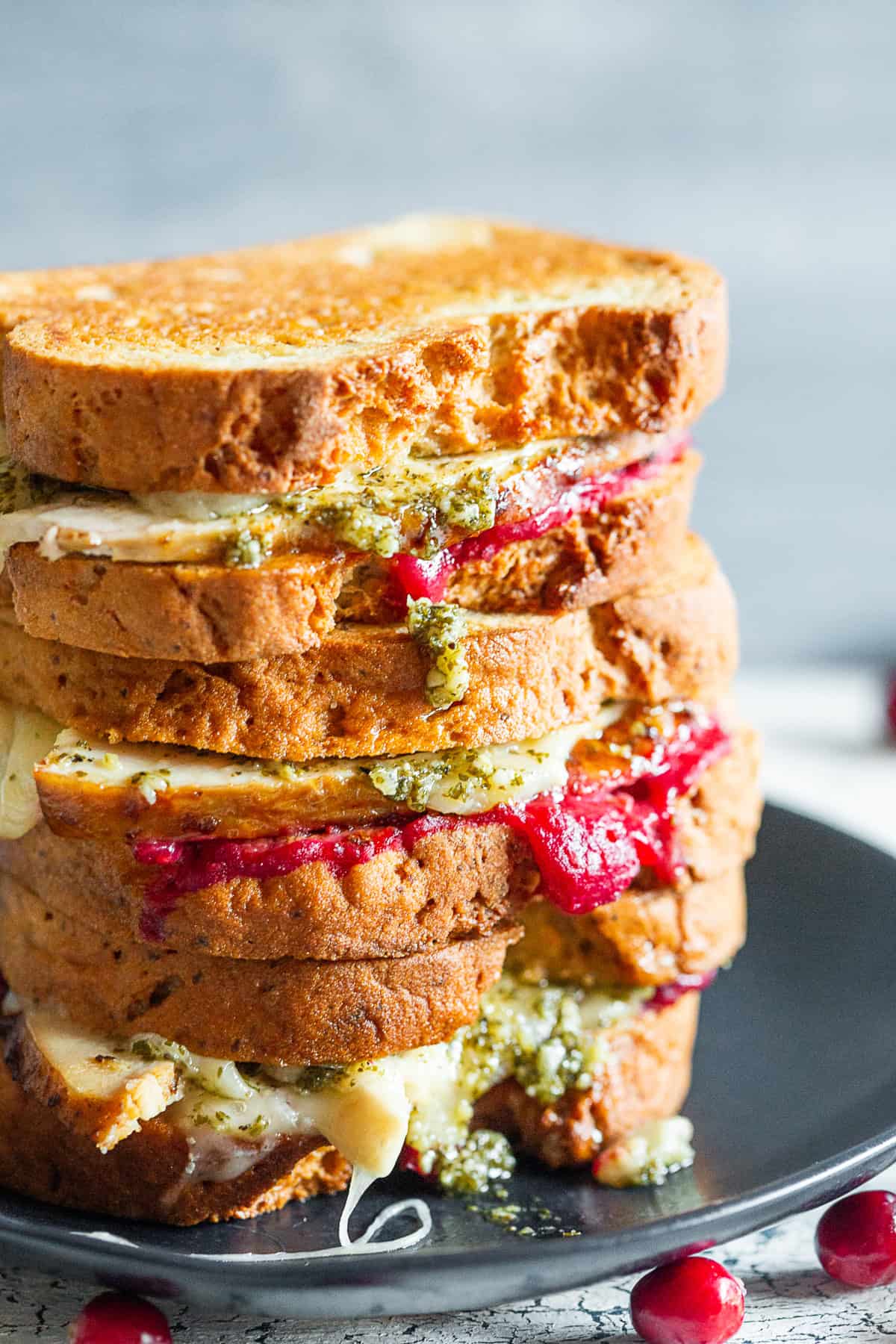 Turkey Cranberry Pesto Panini on a black plate. 