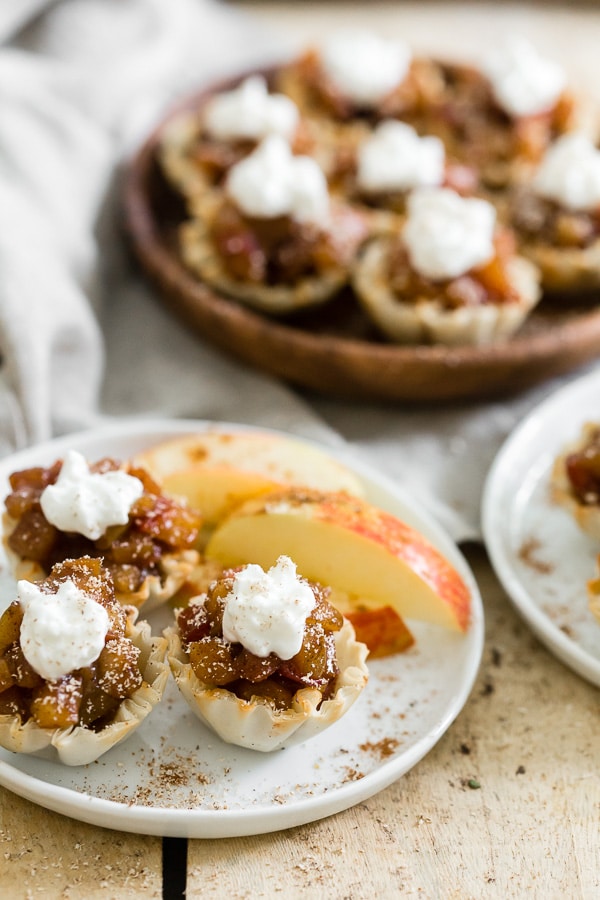 Vanilla Bean Apple Pie Phyllo Bites served with whipped cream. 
