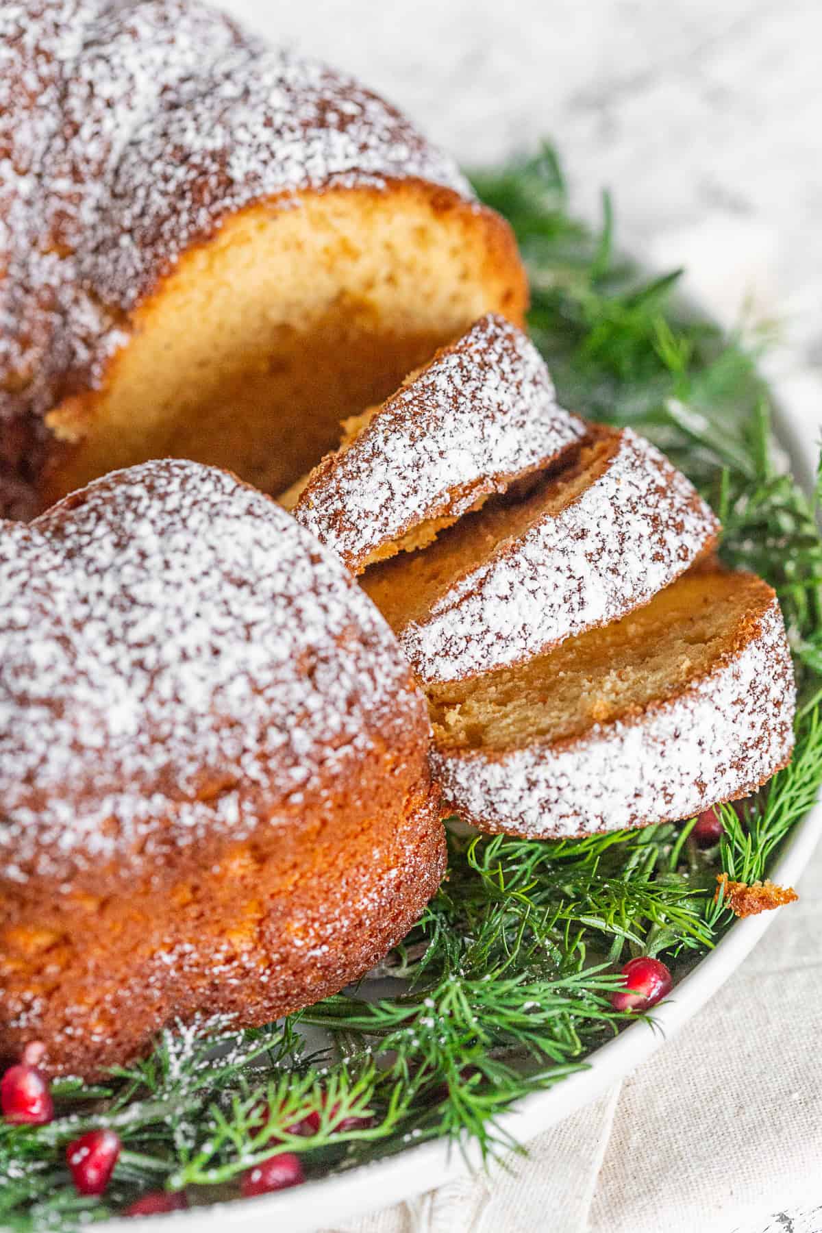 Cream sherry bundt cake sliced on a platter