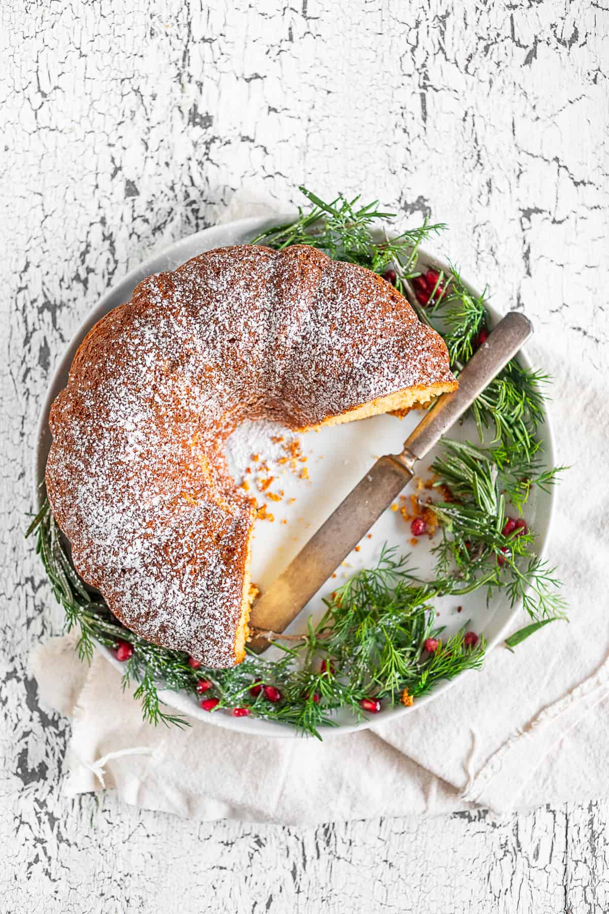 cream sherry bundt cake on a serving platter with a serving knife