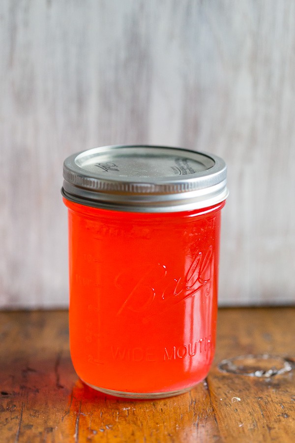 Homemade Candy Cane Vodka in a jar with a lid. 