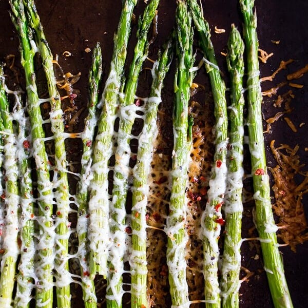 This Parmesan roasted asparagus is sprinkled with Parmesan cheese, crushed red pepper and a little squeeze of lemon. You'll love how simple and delicious this side dish is to make. The best part is the dish is made in just 20 minutes!