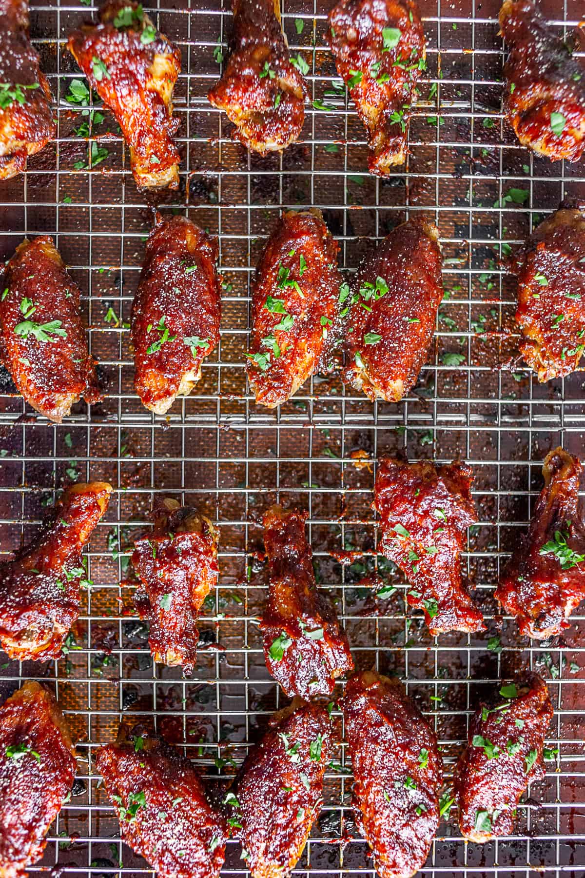 Crispy chicken wings on a grilling tray.