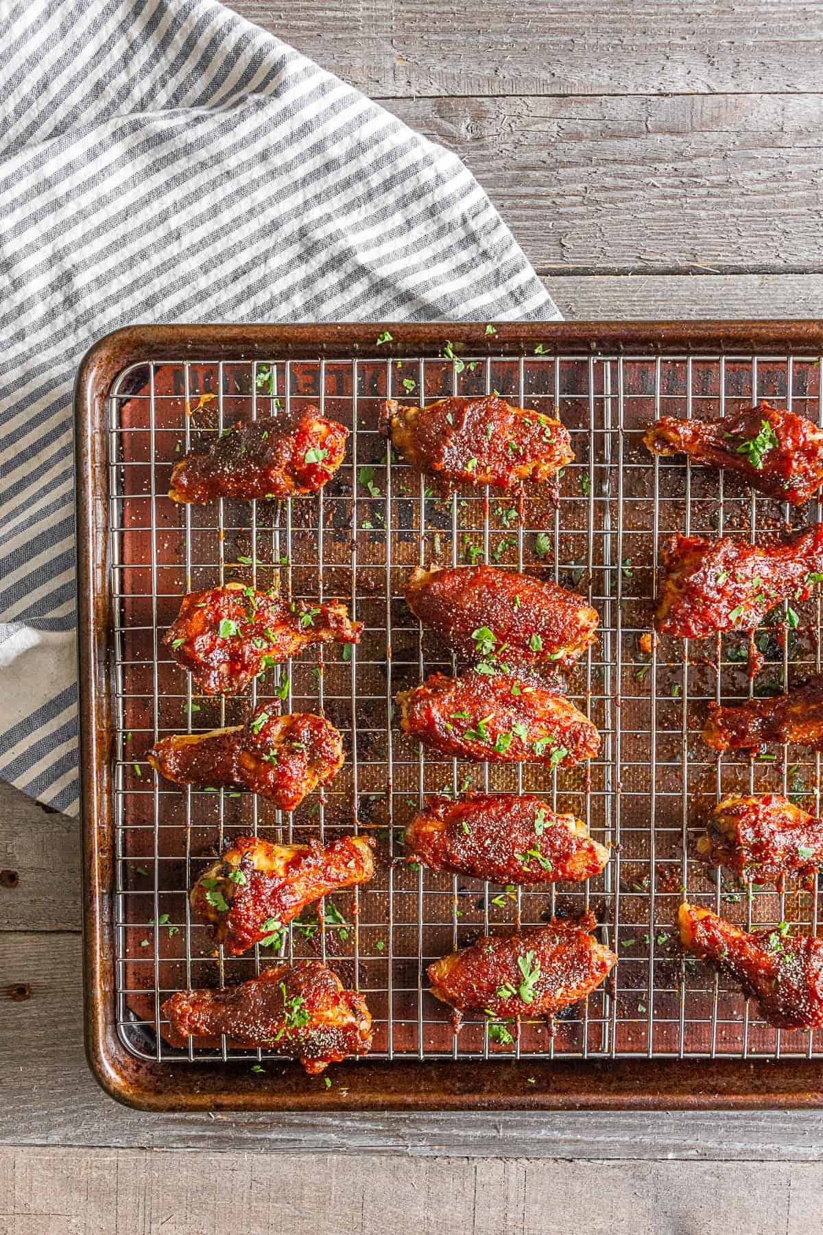 Apple butter chicken wings on a baking tray and grilling rack.