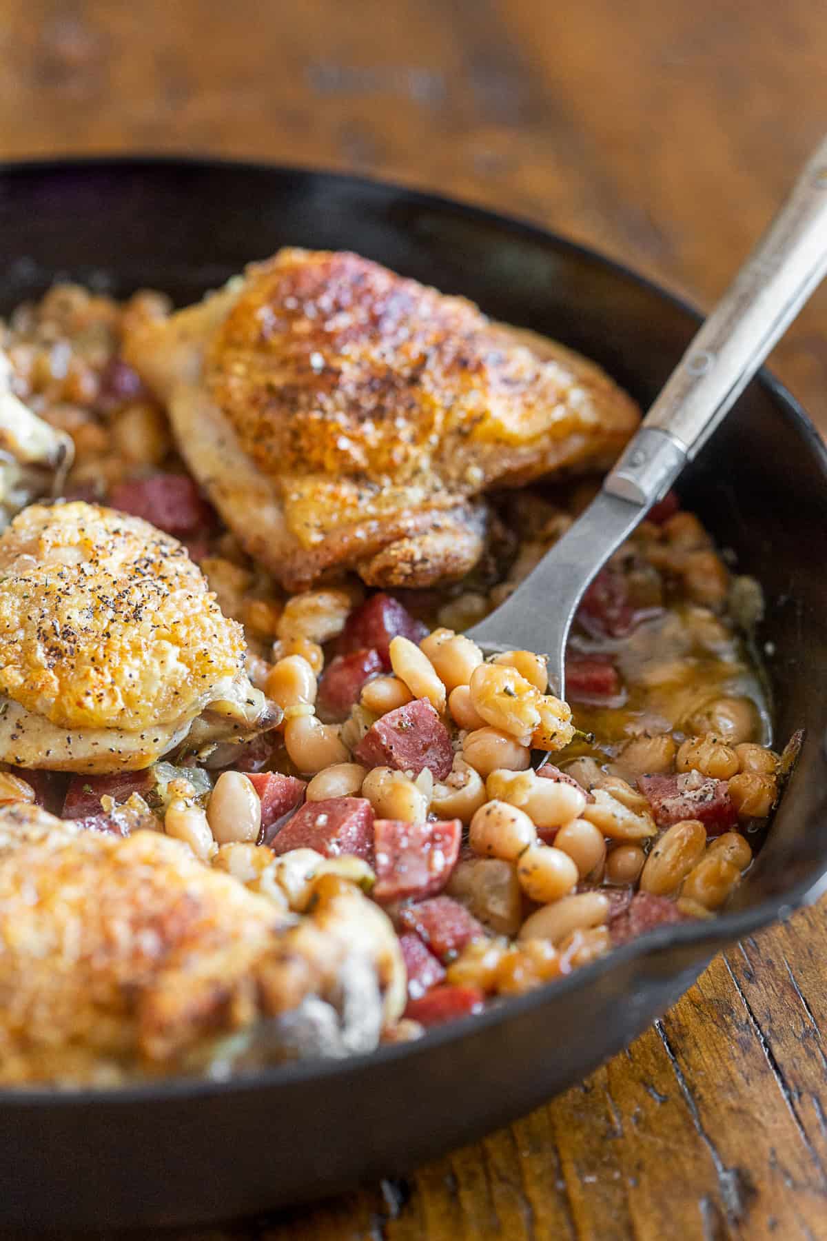 Chicken Cannellini Bean Skillet with a spoon in the skillet. 