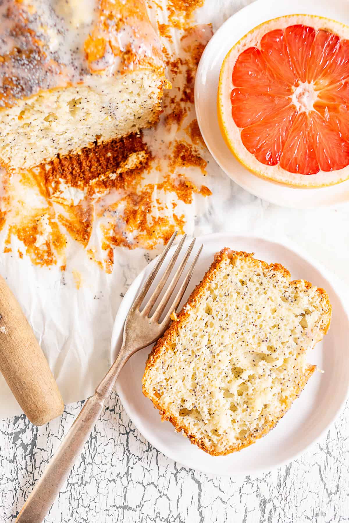 Grapefruit Poppy Seed Cake sliced on a small white plate. 