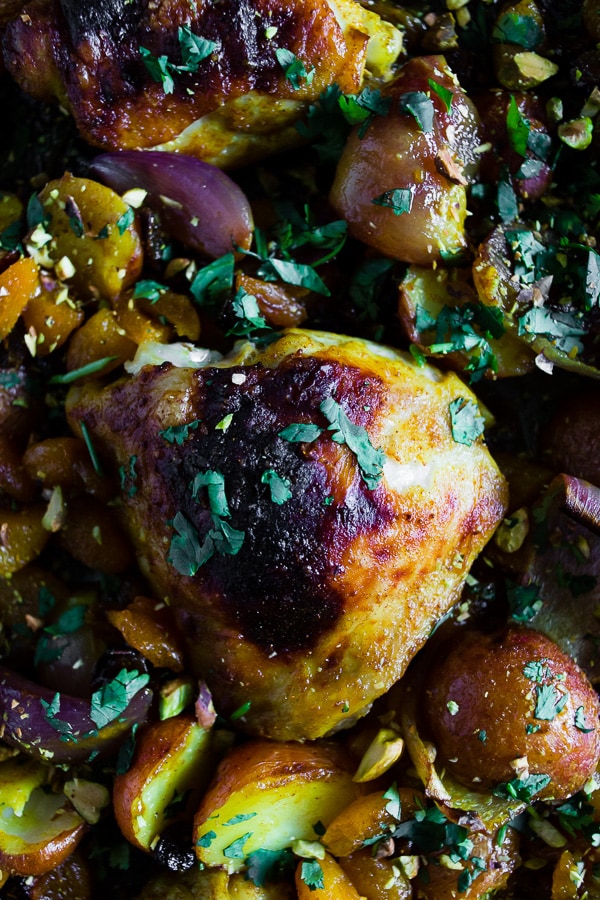 This sheet pan Moroccan chicken and potatoes is flavored with lots of Moroccan spices, dried apricots, golden raisins and a sprinkling of cilantro and pistachios. This dish is super simple to make and only requires 1 sheet pan and 45-50 minutes of roasting!