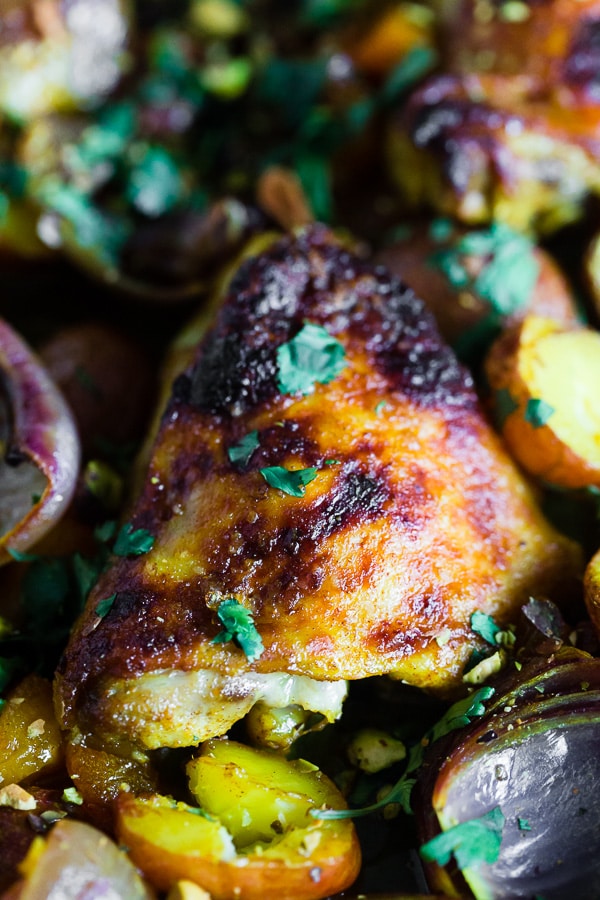 This sheet pan Moroccan chicken and potatoes is flavored with lots of Moroccan spices, dried apricots, golden raisins and a sprinkling of cilantro and pistachios. This dish is super simple to make and only requires 1 sheet pan and 45-50 minutes of roasting!