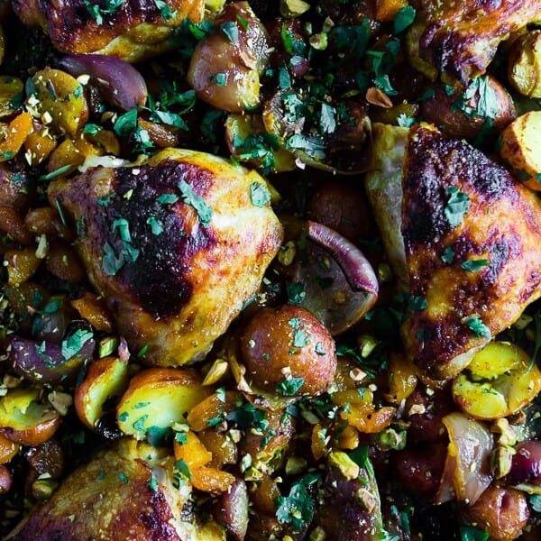 This sheet pan Moroccan chicken and potatoes is flavored with lots of Moroccan spices, dried apricots, golden raisins and a sprinkling of cilantro and pistachios. This dish is super simple to make and only requires 1 sheet pan and 45-50 minutes of roasting!