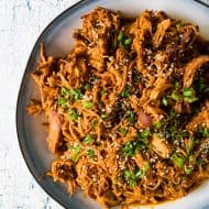 This slow cooker honey soy sriracha pulled chicken is packed full of flavor and made all in the slow cooker. All you need are a few easy ingredients, a slow cooker and 4-6 hours. Serve it over rice, on a bun or straight from the slow cooker!