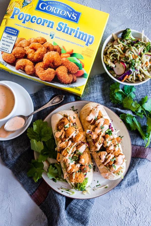Asian Shrimp Po Boy Sandwich on a plate with extra slaw on the side.
