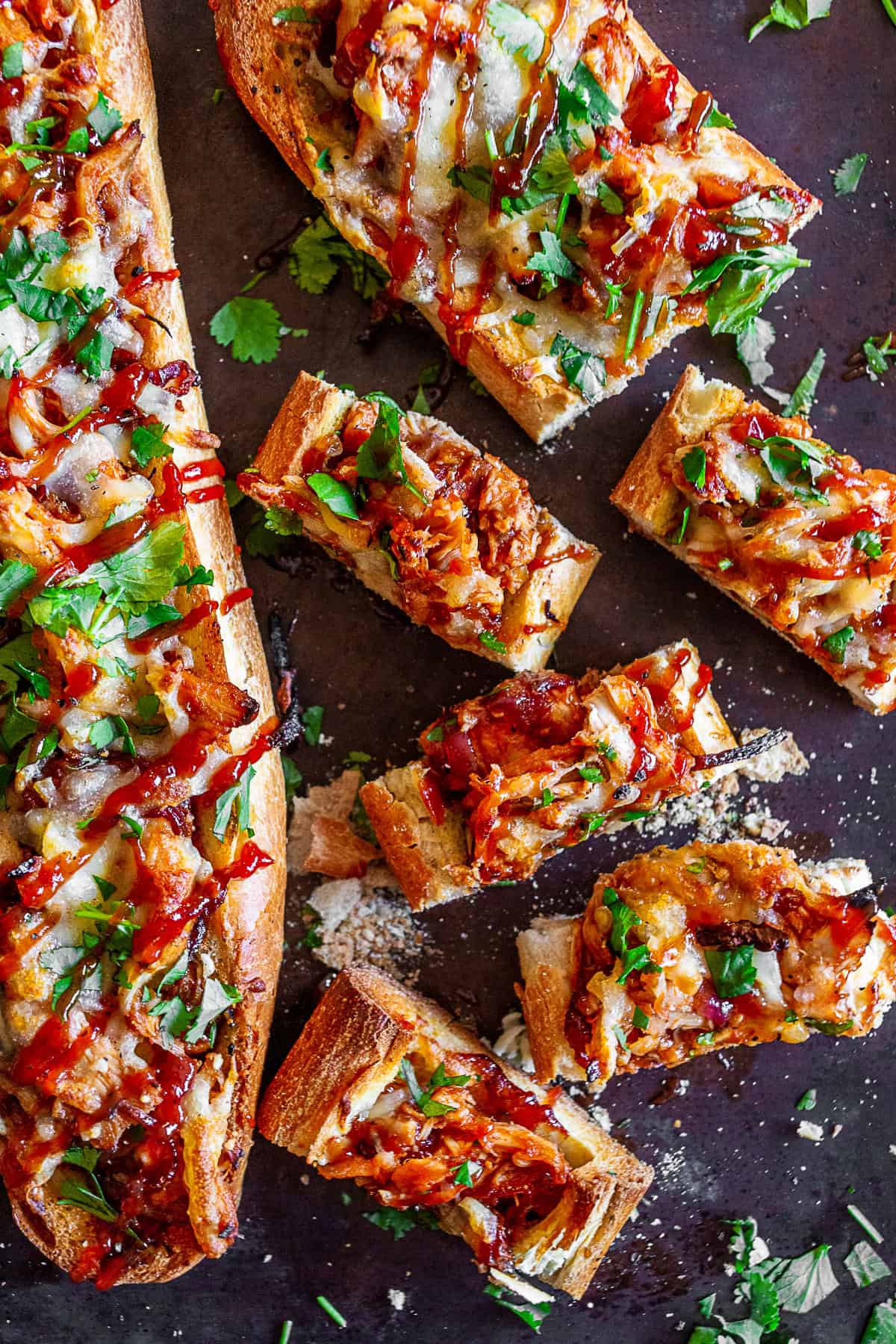 BBQ Chicken French Bread Pizza sliced on a baking sheet pan.