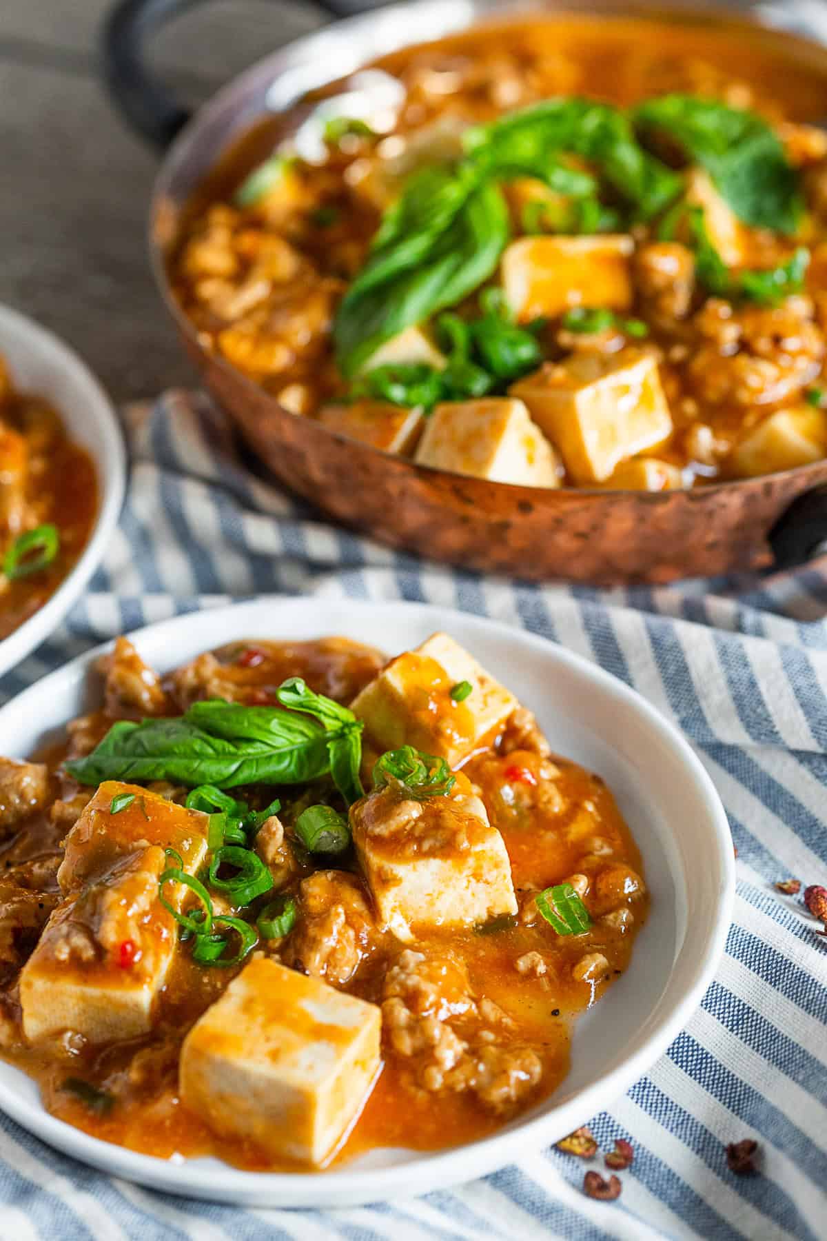 Ground Pork Mapo Tofu topped with fresh basil and green onions. 