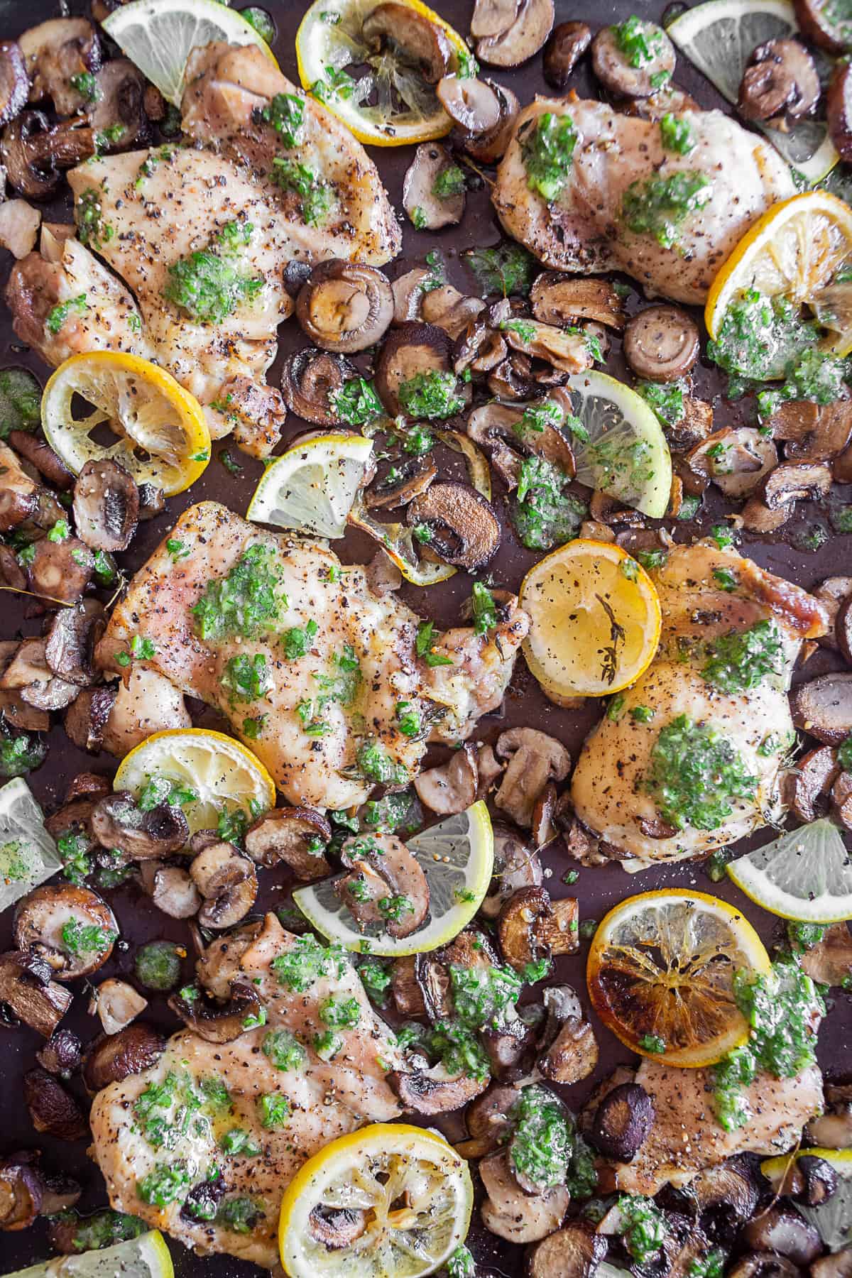 Sheet Pan Garlic Lemon Chicken drizzled with sauce.