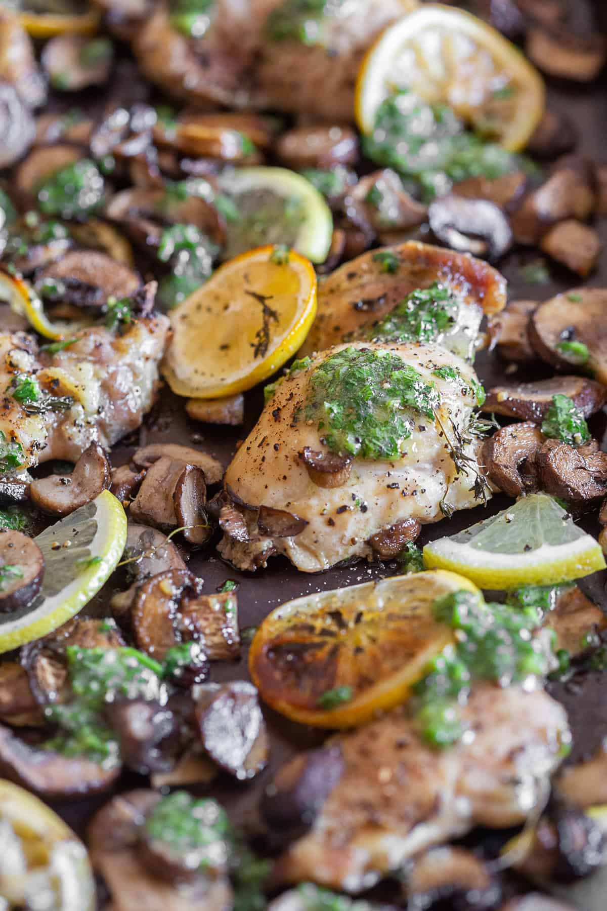 Sheet Pan Garlic Lemon Chicken served with fresh lemon.