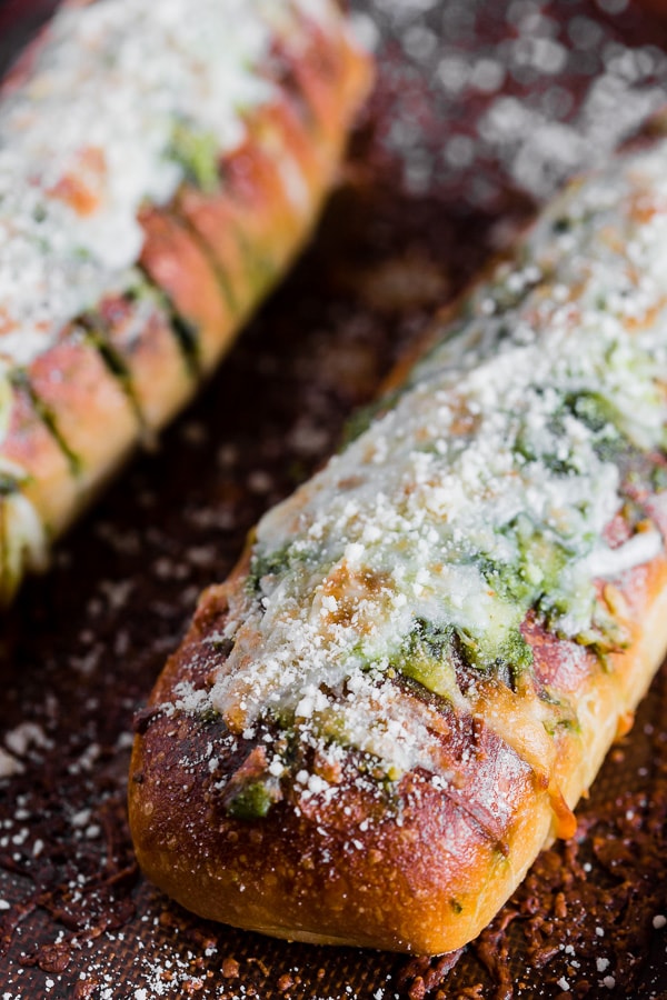 Cheesy Pesto Garlic Bread topped with Parmesan cheese. 