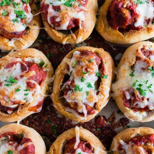 These mini chicken Parmesan meatballs subs totally step up your game day food! Stuffed with homemade chicken Parmesan meatballs, tomato sauce and topped with lots of melty mozzarella cheese. Crazy delicious and ready in under an hour!