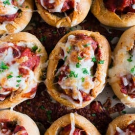 These mini chicken Parmesan meatballs subs totally step up your game day food! Stuffed with homemade chicken Parmesan meatballs, tomato sauce and topped with lots of melty mozzarella cheese. Crazy delicious and ready in under an hour!