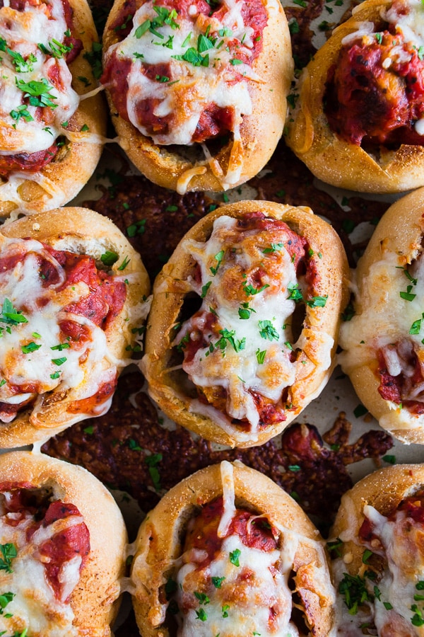 Mini Chicken Parmesan Meatball Subs served with a sprinkle of parsley. 