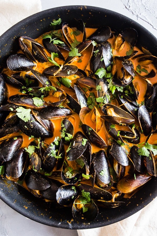 Coconut Curry Mussels in a skillet.