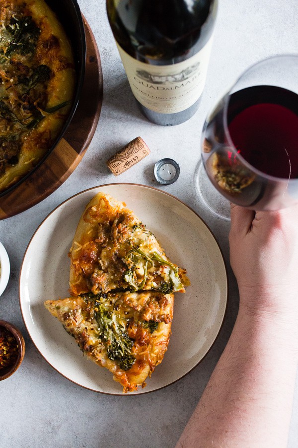 Sausage Broccoli Rabe Skillet Pizza served with wine.