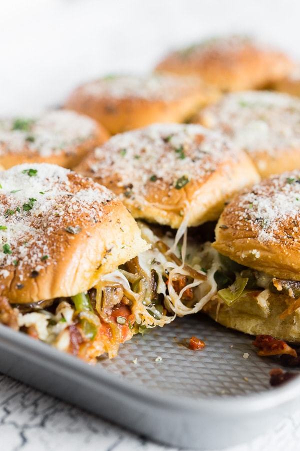 Baked Supreme Pizza Sliders sitting in a sheet pan. 