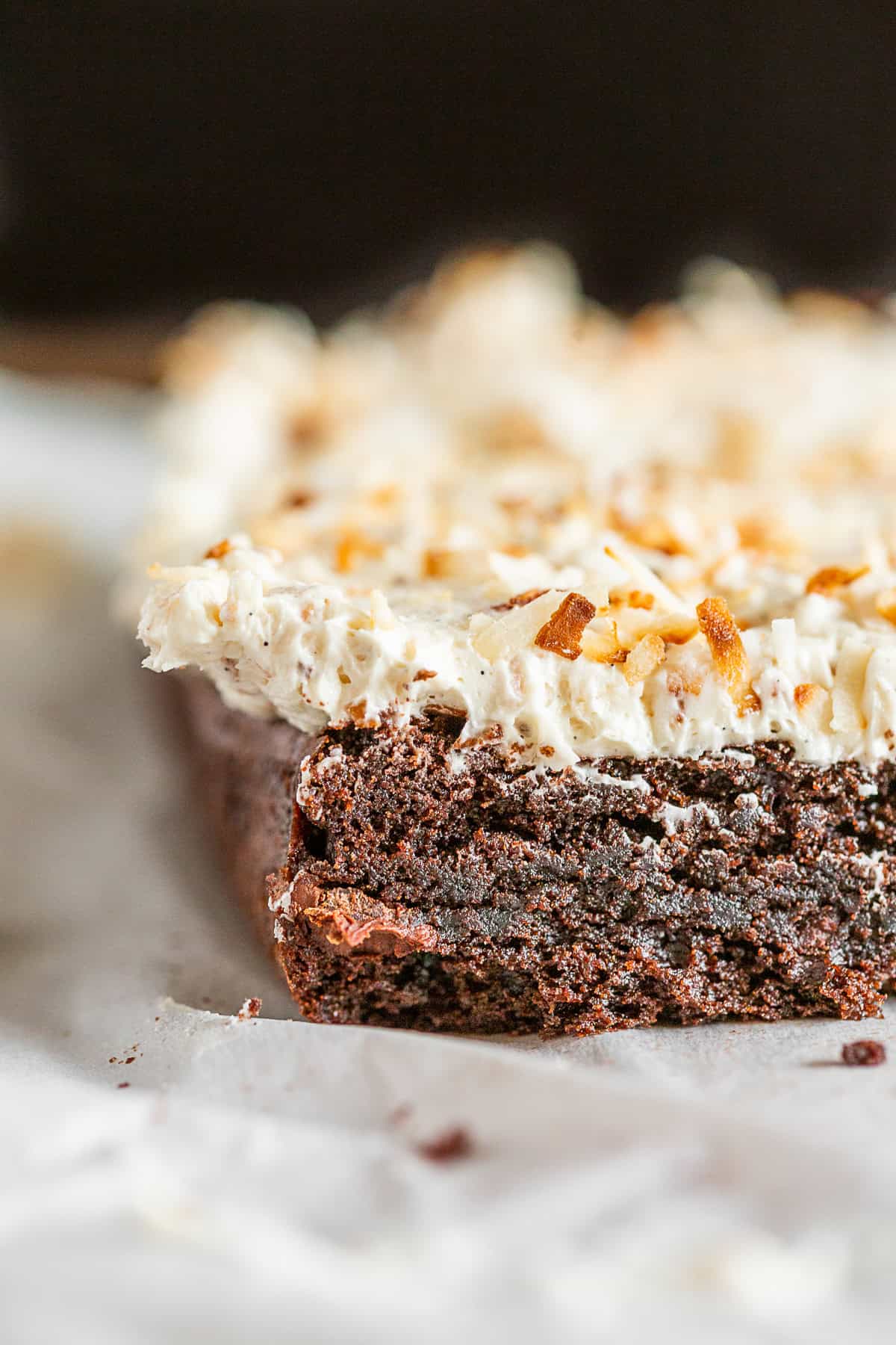 A sliced brownie with frosting on top.
