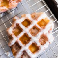 apple butter waffle donuts glazed sitting on a drying rack