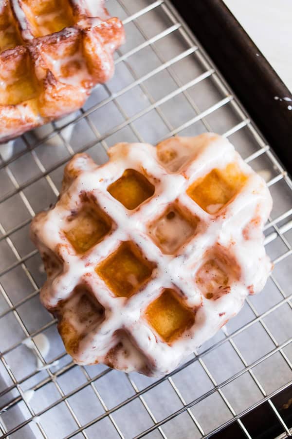 These apple butter waffle donuts are the perfect sweet Easter brunch treat. Perfectly spiced apple butter waffles fried to donut perfection and dipped in a vanilla bean glaze. You'll love these sweet little donut treats.
