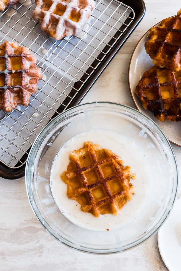 These apple butter waffle donuts are the perfect sweet Easter brunch treat. Perfectly spiced apple butter waffles fried to donut perfection and dipped in a vanilla bean glaze. You'll love these sweet little donut treats.