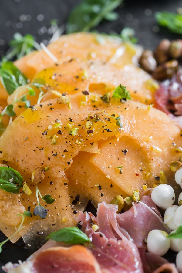 Cantaloupe Caprese Salad drizzled with dressing. 