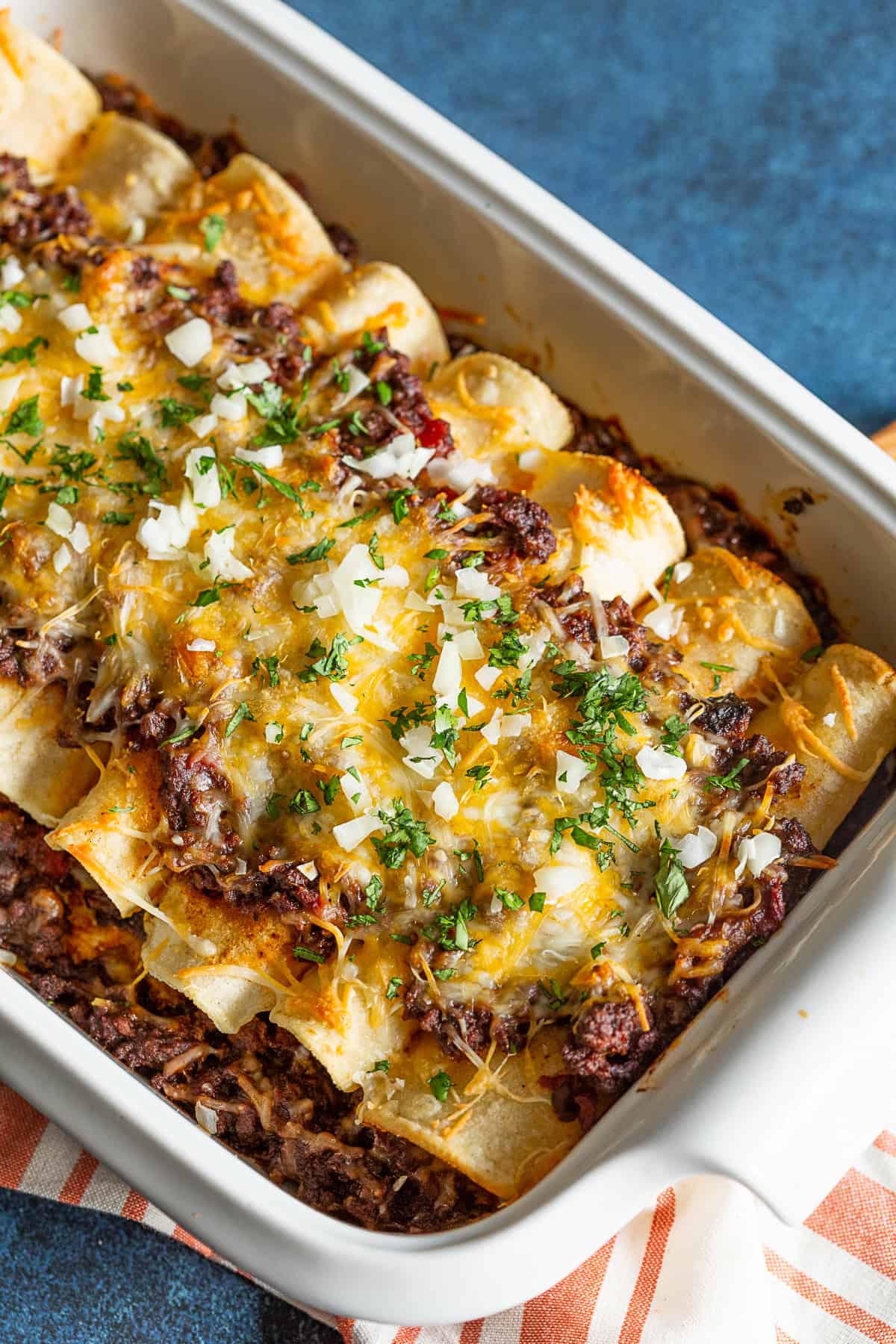 Chipotle Ground Beef Enchiladas topped with minced cilantro and onion. 